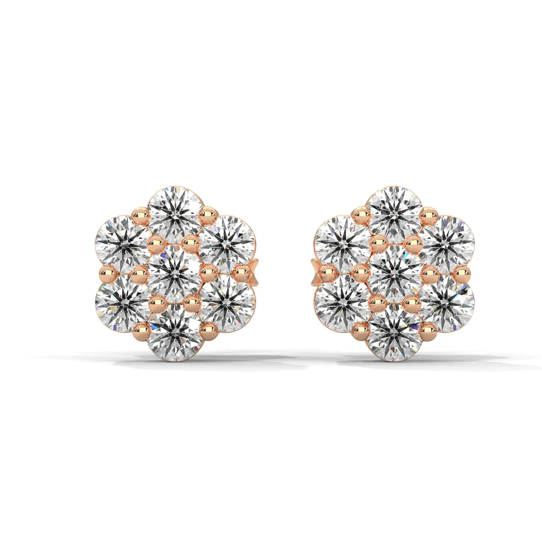 A pair of rose gold and diamond flower-shaped stud earrings on a white background.