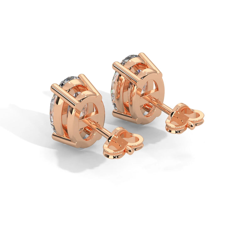 Pair of rose gold diamond stud earrings on a white background.