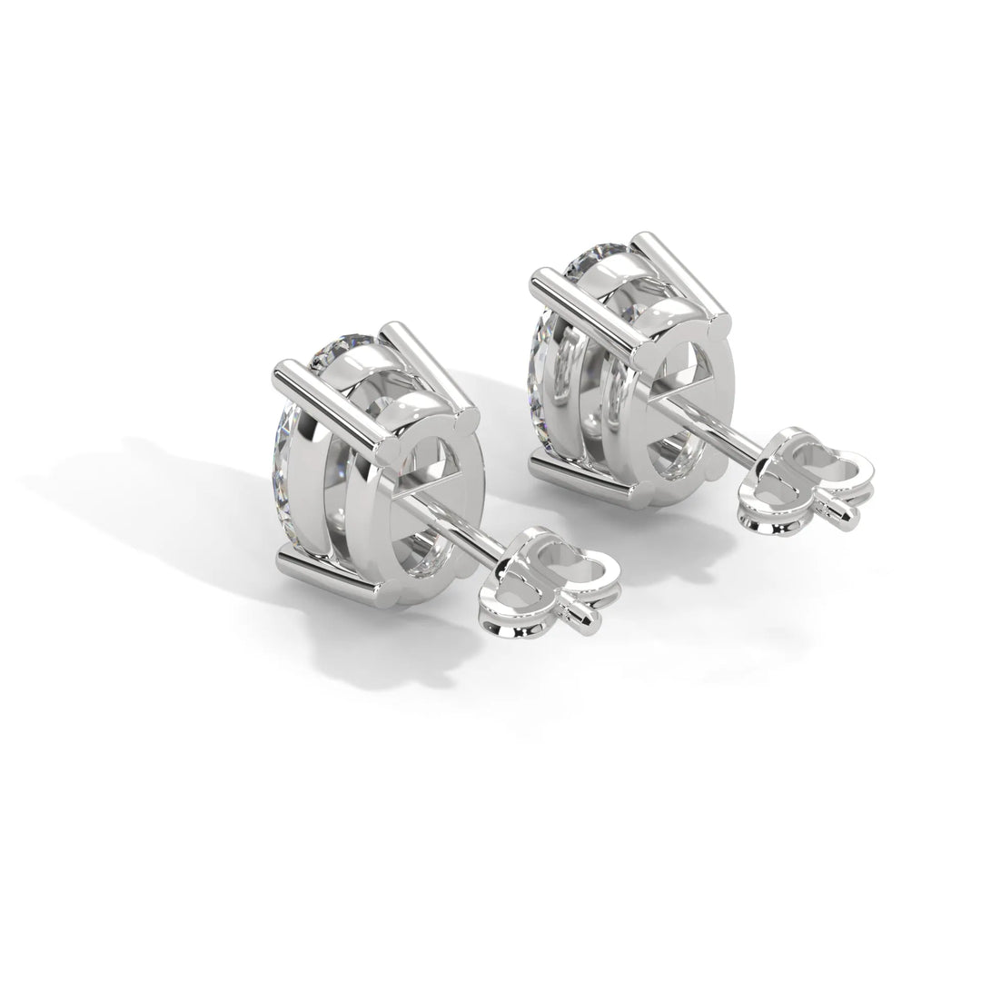 Pair of silver cufflinks with central gemstone on a white background.