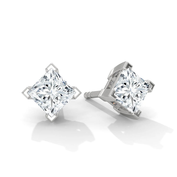 A pair of square diamond stud earrings on a white background.