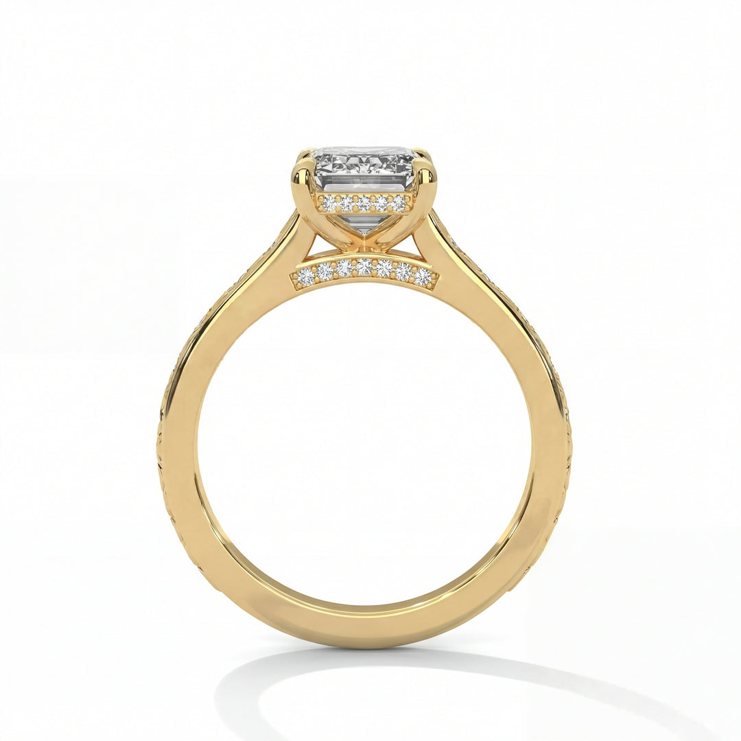 Side profile view of radiant cut diamond engagement ring in yellow gold with hidden halo and pave diamond bridge detailing