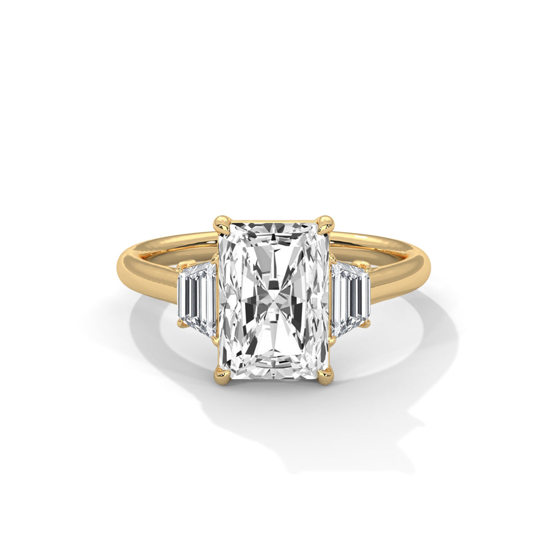 A radiant cut diamond ring with a gold band, featuring a large central diamond flanked by two smaller baguette diamonds, exuding elegance and luxury.