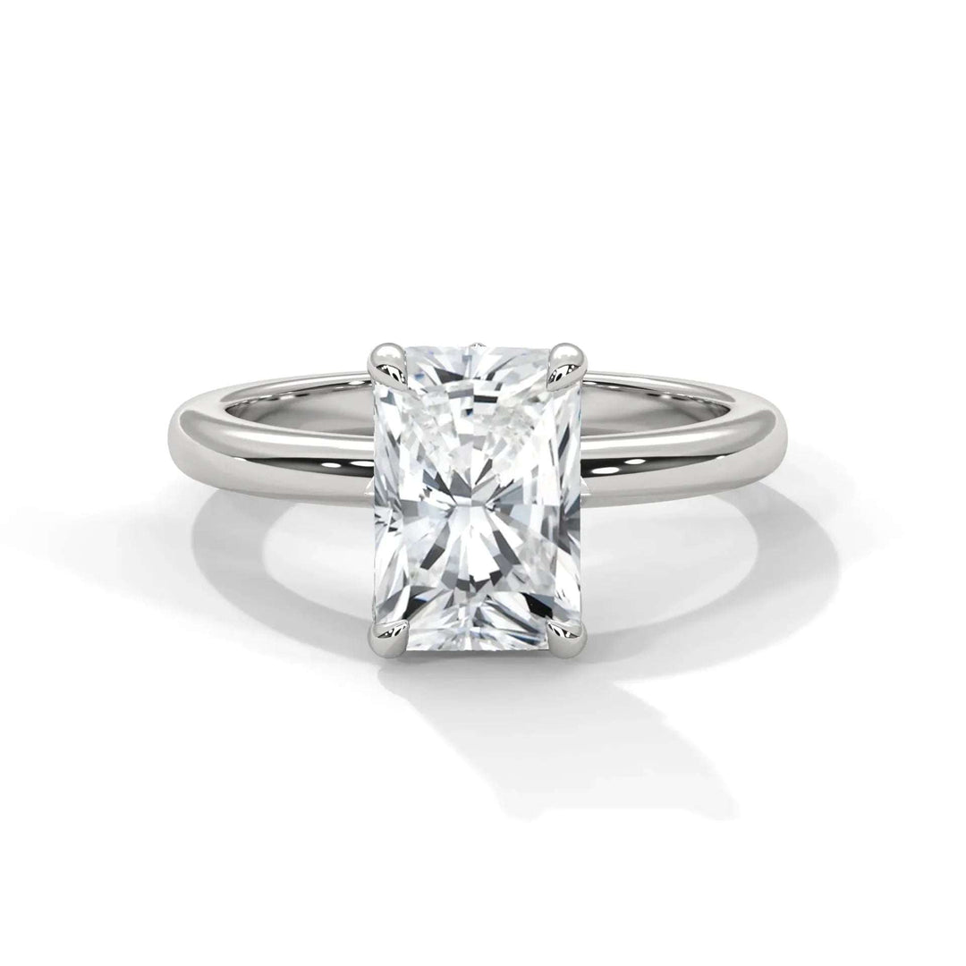 A radiant-cut diamond ring set in a sleek platinum band. The diamond's facets sparkle in the light, conveying elegance and sophistication.