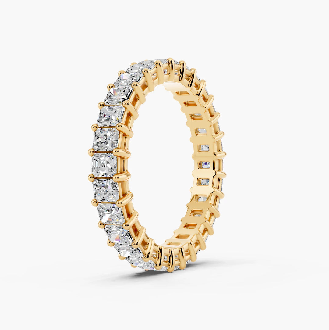 2 carat radiant cut diamond eternity band in yellow gold, angled view