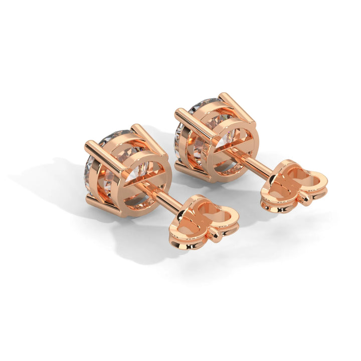 Rose gold cufflinks with a clear central stone on a white background.