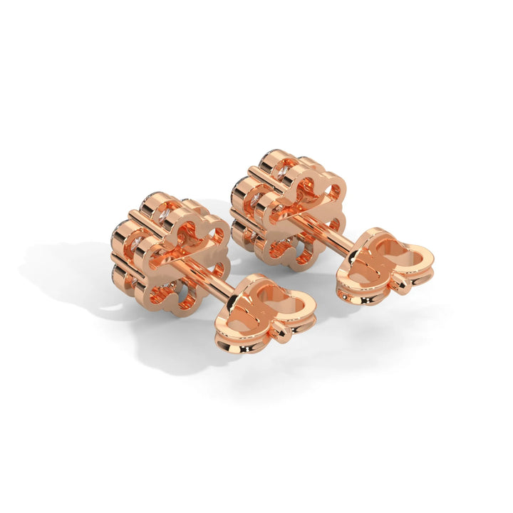 Rose gold dumbbells shaped like bones on a white background.