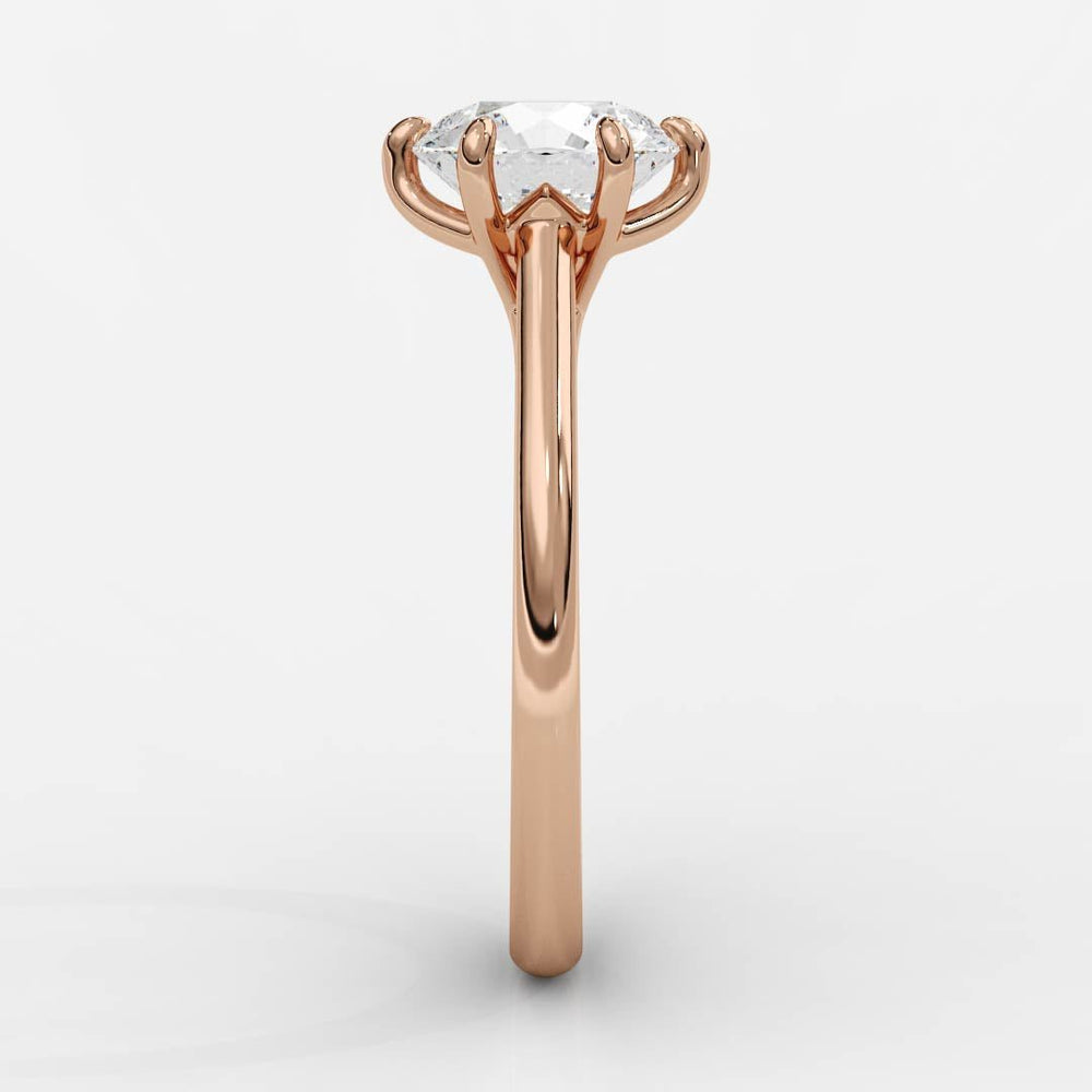 rose gold engagement ring with tapered cathedral setting and diamond solitaire viewed from side
