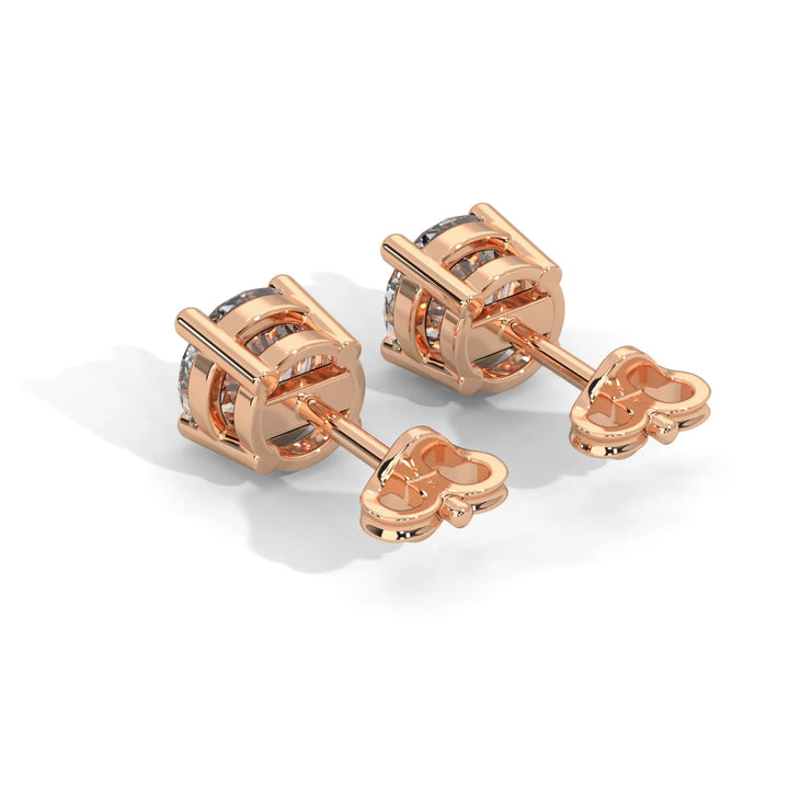 Rose gold knot style cufflinks with a central gemstone on a light background.