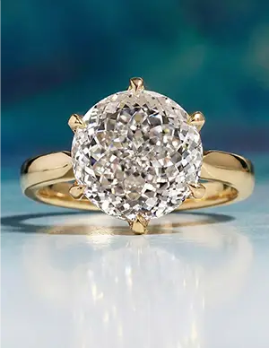 Classic gold solitaire engagement ring featuring a round brilliant-cut diamond