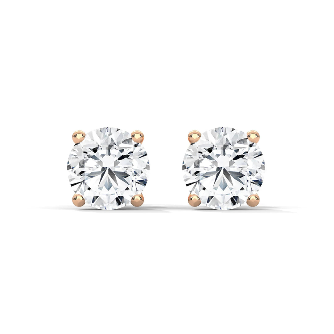 Round diamond stud earrings with rose gold settings on a white background.