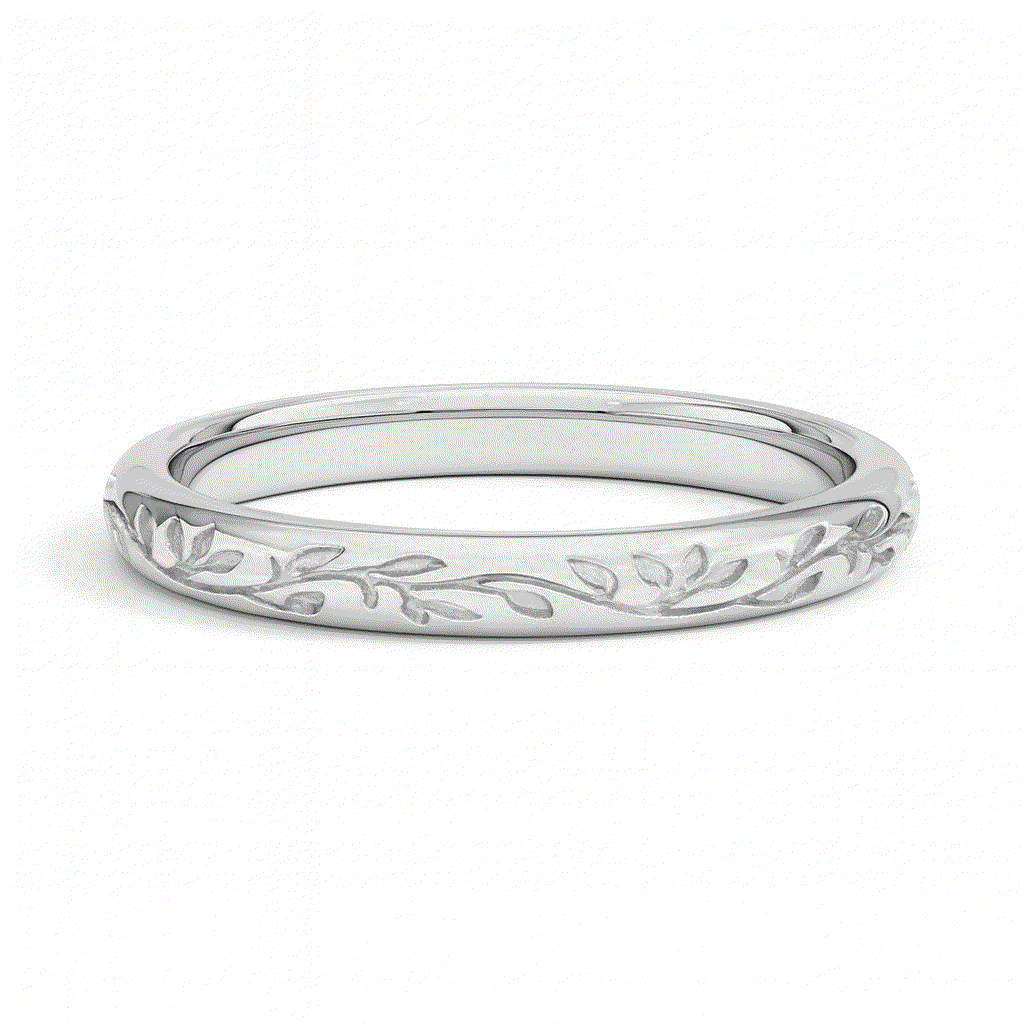 A silver ring with a delicate, engraved leaf and vine pattern encircling the band, set against a white background. The design is elegant and intricate.