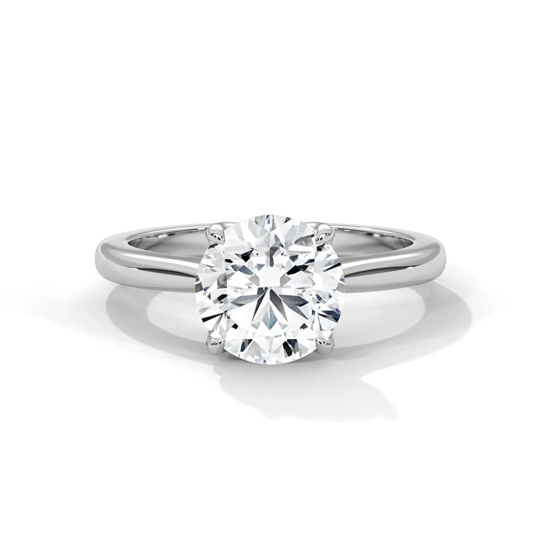 A silver ring with a large, round-cut diamond set in a simple band. The diamond sparkles brilliantly, conveying elegance and sophistication.
