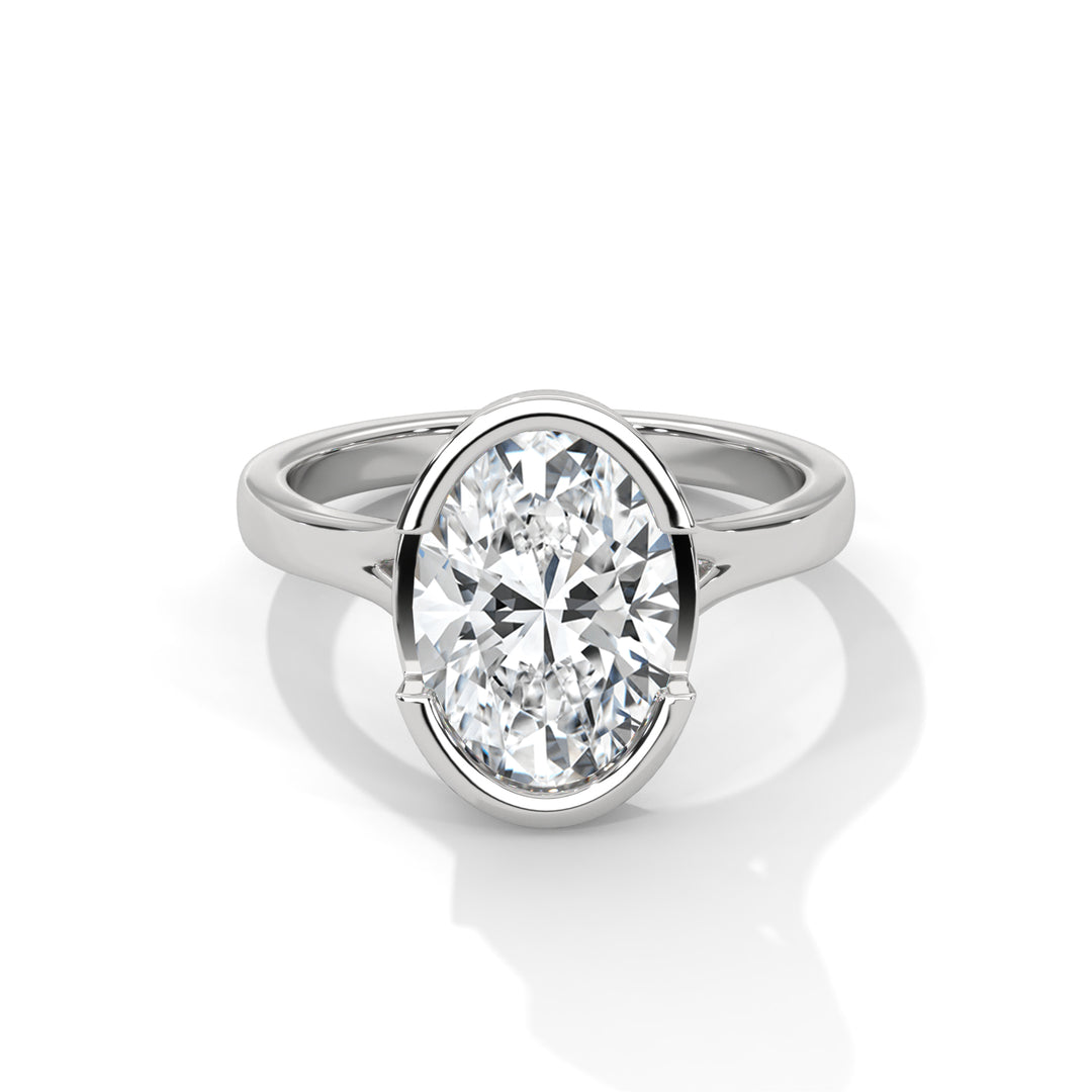 A shiny silver ring with an elegant oval-shaped diamond in the center. The clear gemstone reflects light, giving a sense of luxury and sophistication.