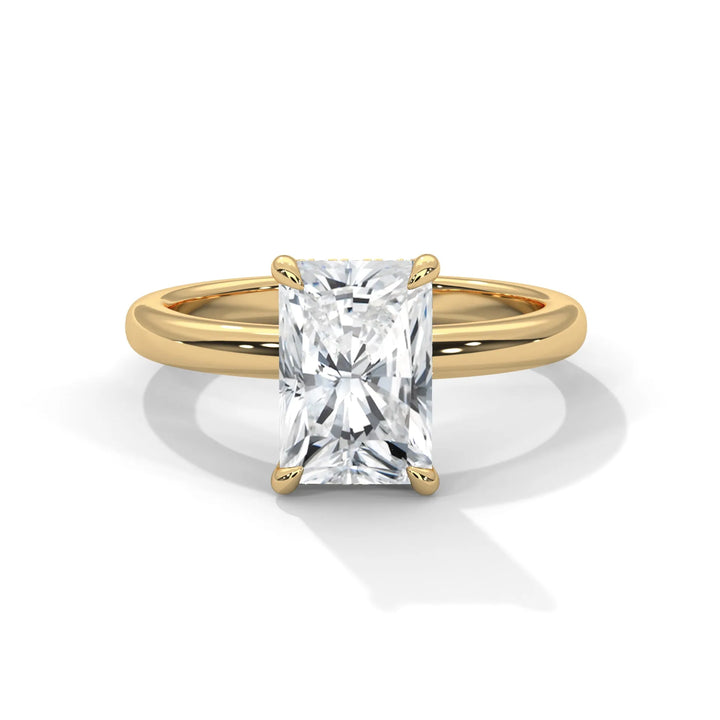 Gold ring with a square-cut diamond on a white background.