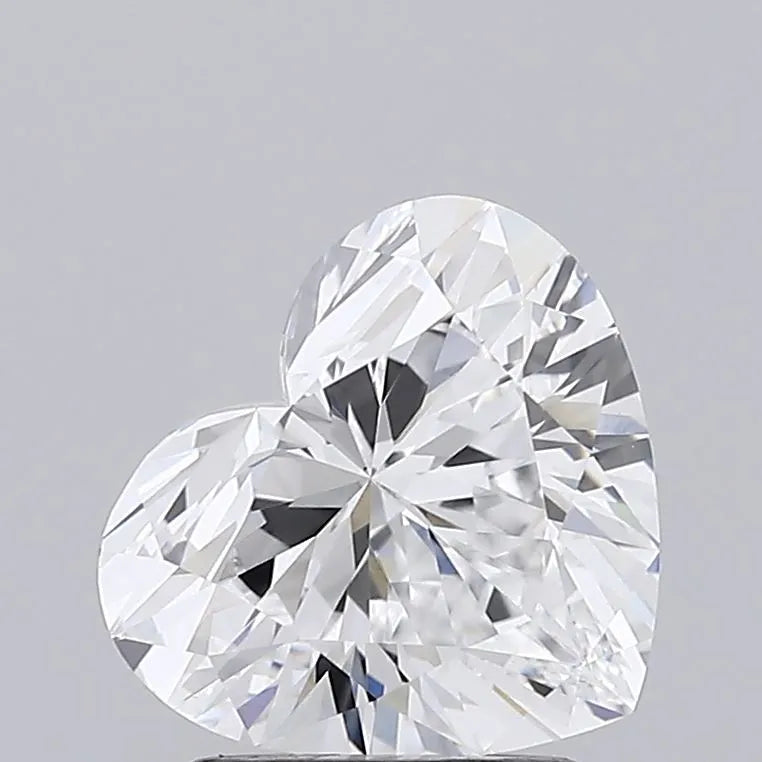 Heart-shaped diamond resting on a white background, showcasing its brilliance and unique cut.