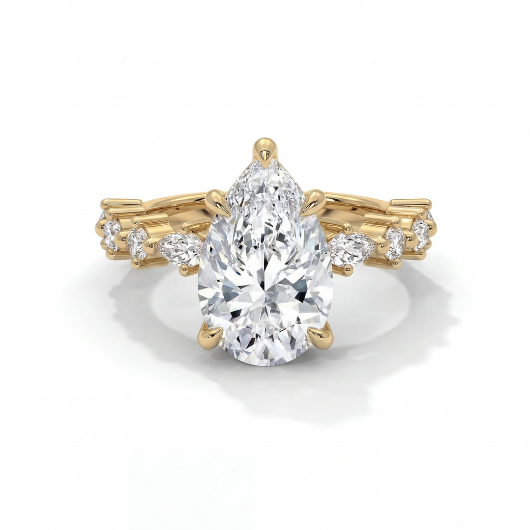 A stunning pear-shaped diamond ring set on a gold band with intricate design, featuring smaller round diamonds, conveys elegance and luxury.