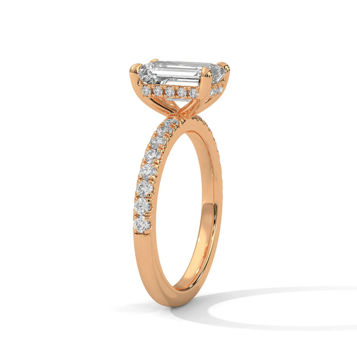 A beautiful rose gold engagement ring with an emerald 14k rose gold diamond centerpiece, crafted in a Sun Belt setting.