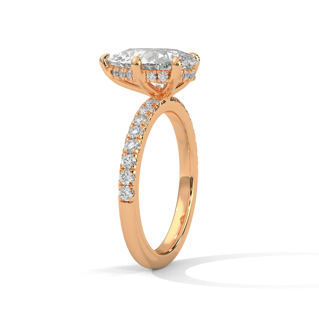 A beautiful rose gold engagement ring with an pear 14k rose gold diamond centerpiece, crafted in a Sun Belt setting.