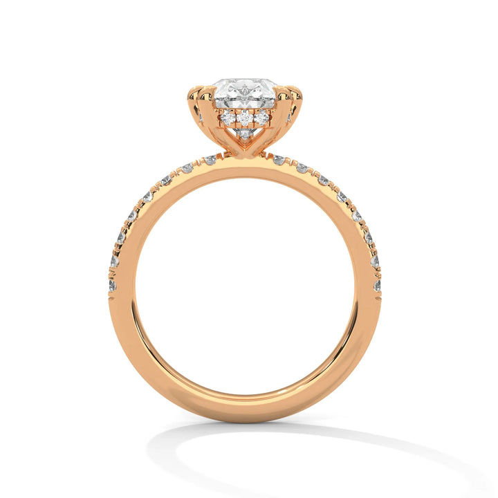 A rose gold engagement ring featuring a stunning pear diamond center in a Sun Belt setting.