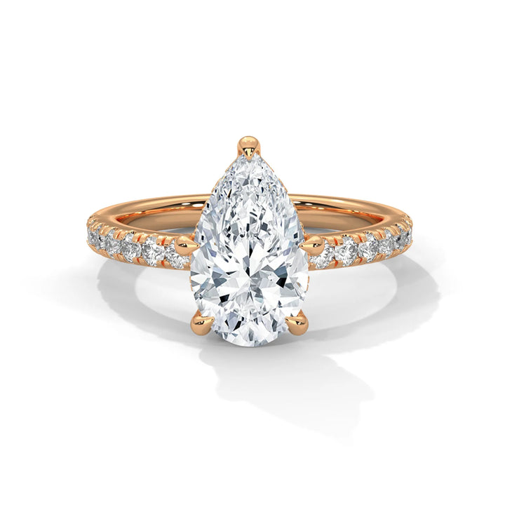 An exquisite pear 14k diamond engagement ring in rose gold, highlighted by a sophisticated Sun Belt setting for a timeless look.