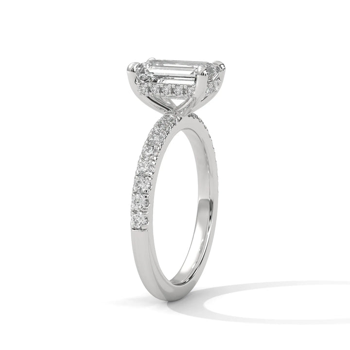 A beautiful white gold engagement ring with an emerald 14k white gold diamond centerpiece, crafted in a Sun Belt setting.