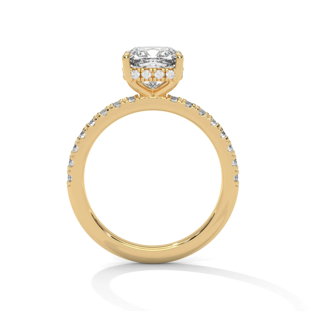 A yellow gold engagement ring featuring a stunning cushion diamond center in a Sun Belt setting.