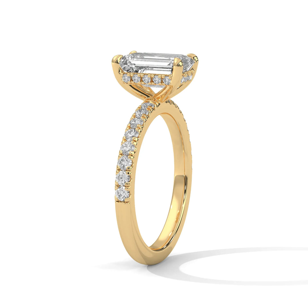 A beautiful yellow gold engagement ring with an emerald 14k yellow gold diamond centerpiece, crafted in a Sun Belt setting.