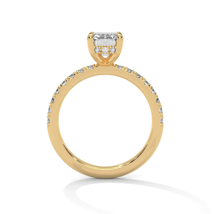 A yellow gold engagement ring featuring a stunning emerald diamond center in a Sun Belt setting.