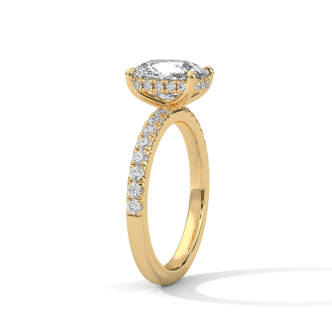 A beautiful yellow gold engagement ring with an long cushion 14k yellow gold diamond centerpiece, crafted in a Sun Belt setting.