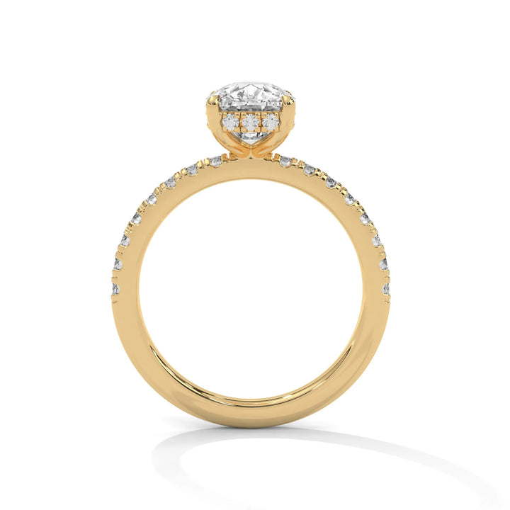 A yellow gold engagement ring featuring a stunning long cushion diamond center in a Sun Belt setting.