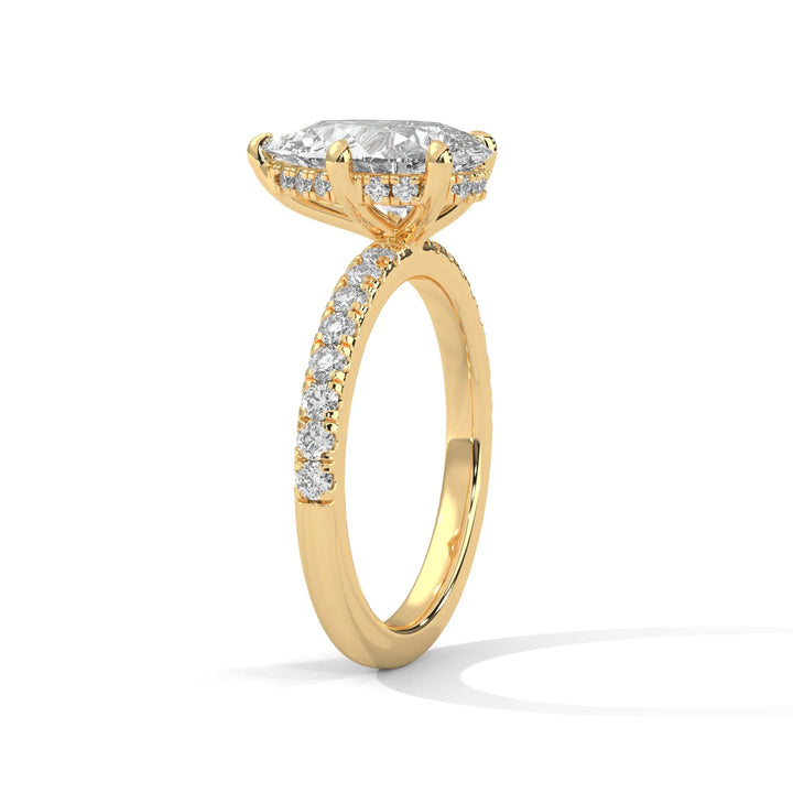 A beautiful yellow gold engagement ring with an pear 14k yellow gold diamond centerpiece, crafted in a Sun Belt setting.