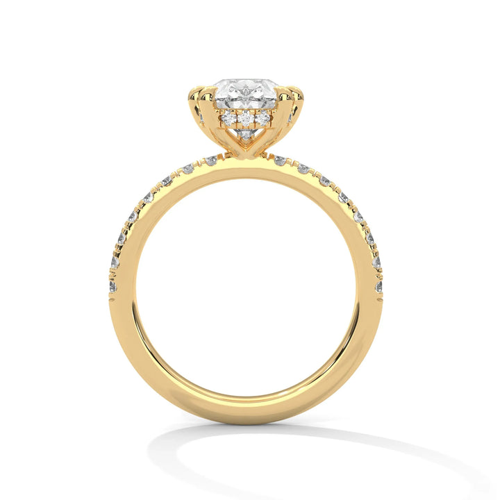 A yellow gold engagement ring featuring a stunning pear diamond center in a Sun Belt setting.