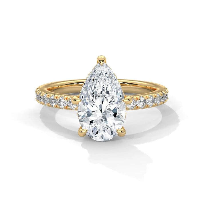 An exquisite pear 14k diamond engagement ring in yellow gold, highlighted by a sophisticated Sun Belt setting for a timeless look.