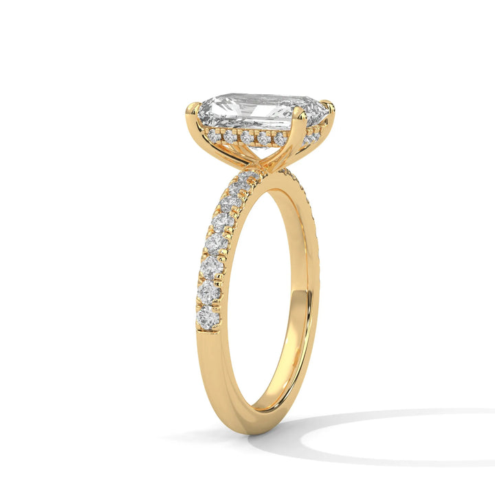 A yellow gold engagement ring featuring a stunning radiant diamond center in a Sun Belt setting.