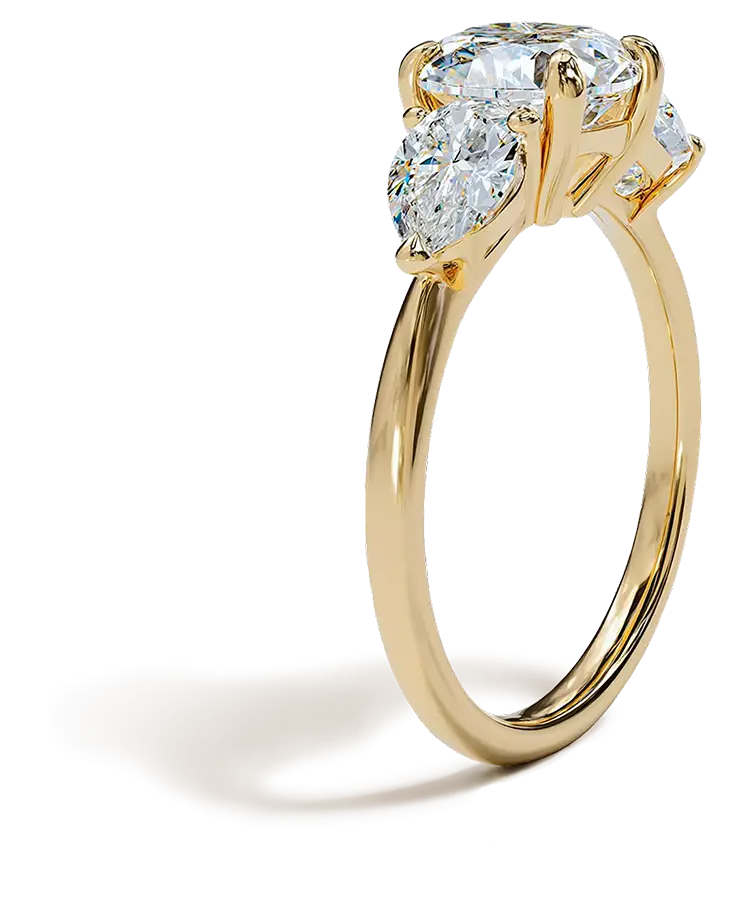 Side view of a gold engagement ring featuring an oval diamond with two marquise side stones