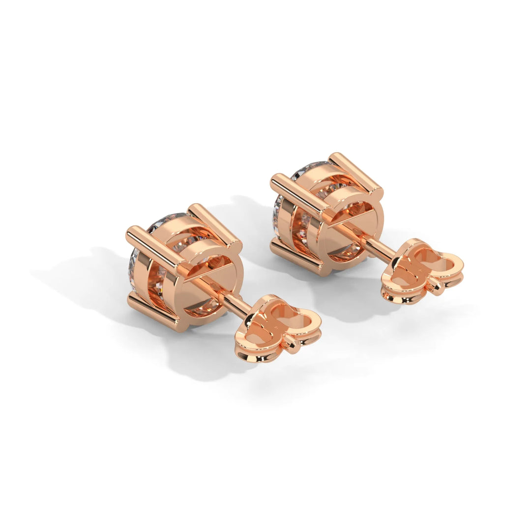 Two elegant rose gold stud earrings adorned with sparkling diamonds perfect for adding a touch of glamour.